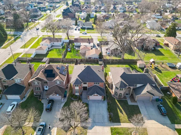 an aerial view of residential houses with outdoor space and swimming pool