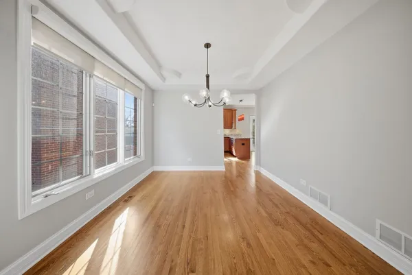 a view of a room with wooden floor staircase and a kitchen
