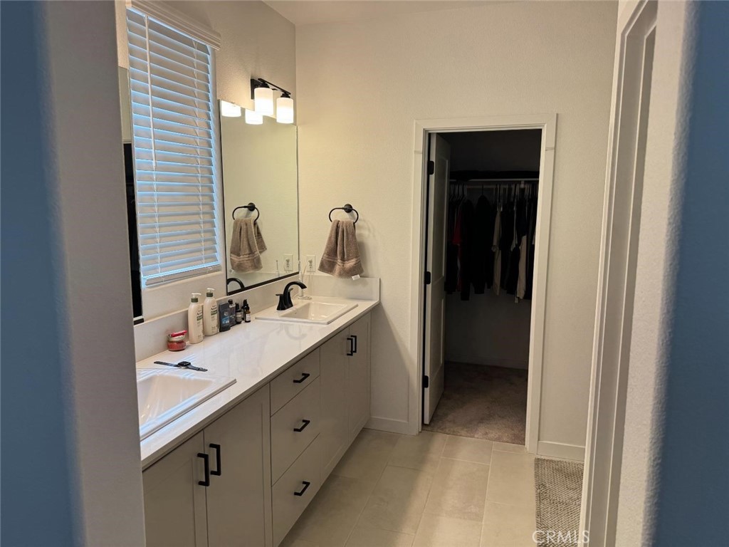 4035 Braden Road Madera, CA 93636 - Photo 15 of 29 a bathroom with a double vanity sink and mirror