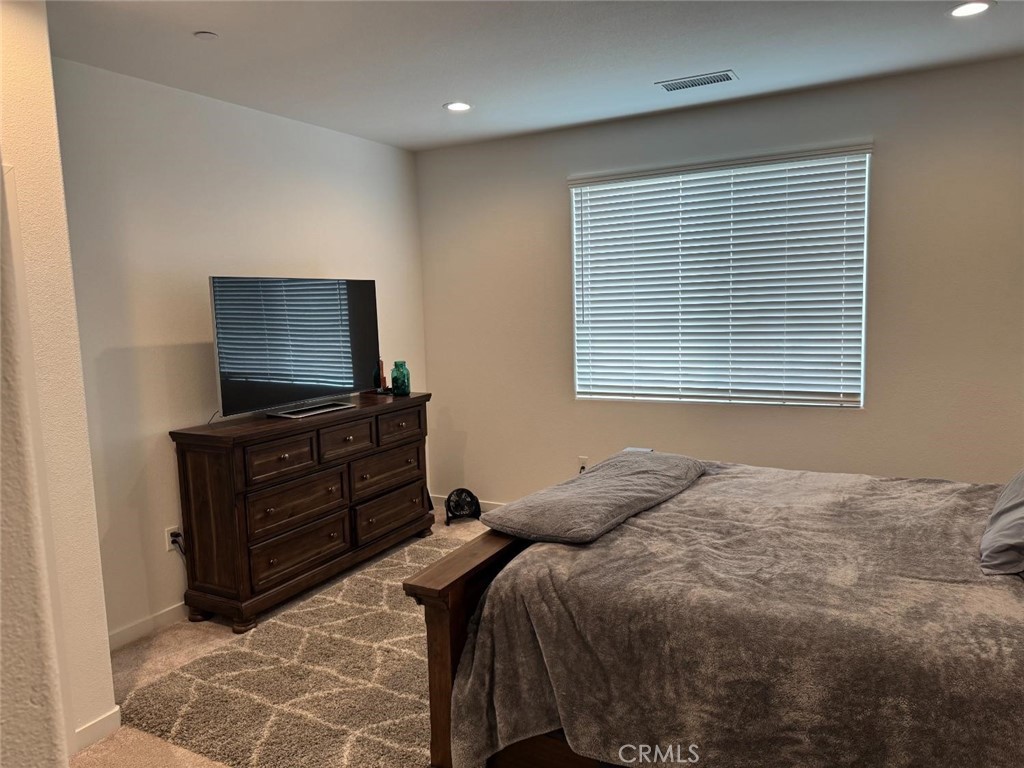 4035 Braden Road Madera, CA 93636 - Photo 19 of 29 a bedroom with a bed and a flat screen tv