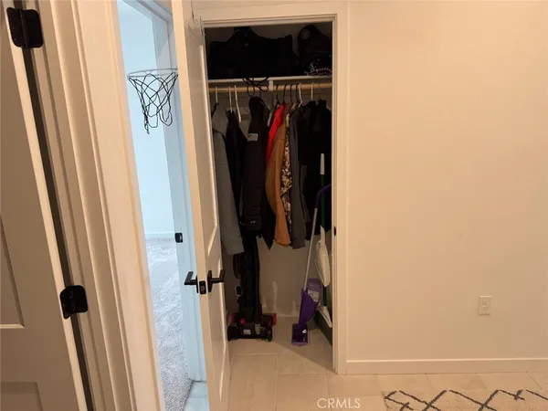 a view of walk in closet with clothes