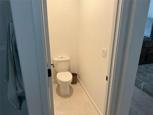 a white toilet sitting next to a shower