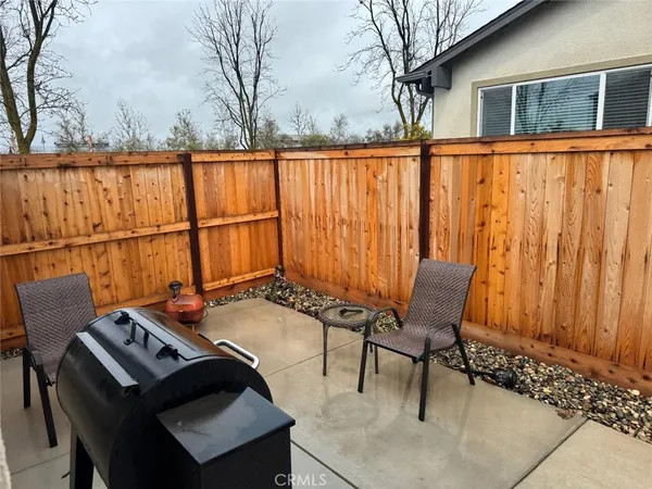 a backyard of a house with table and chairs
