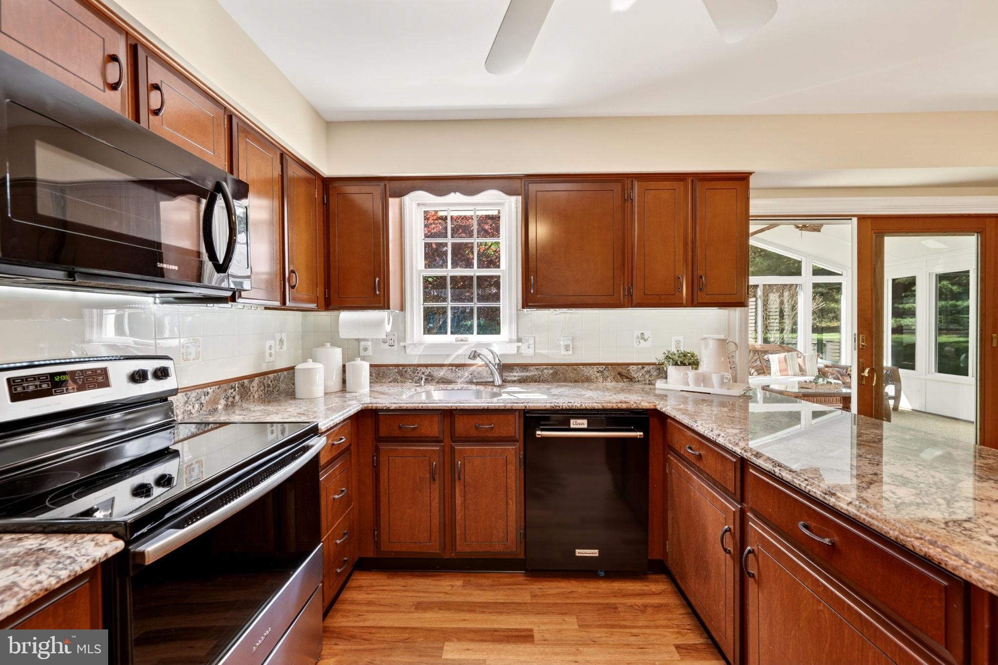 3805 Duddington Way Phoenix, MD 21131 - Photo 20 of 69 a kitchen with stainless steel appliances granite countertop a sink stove and microwave