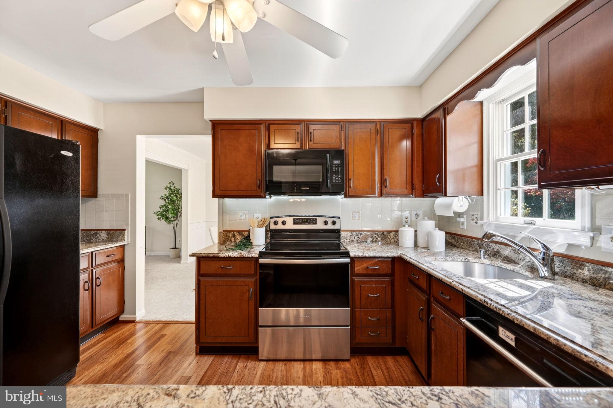 3805 Duddington Way Phoenix, MD 21131 - Photo 21 of 69 a kitchen with stainless steel appliances granite countertop a stove a sink and a refrigerator