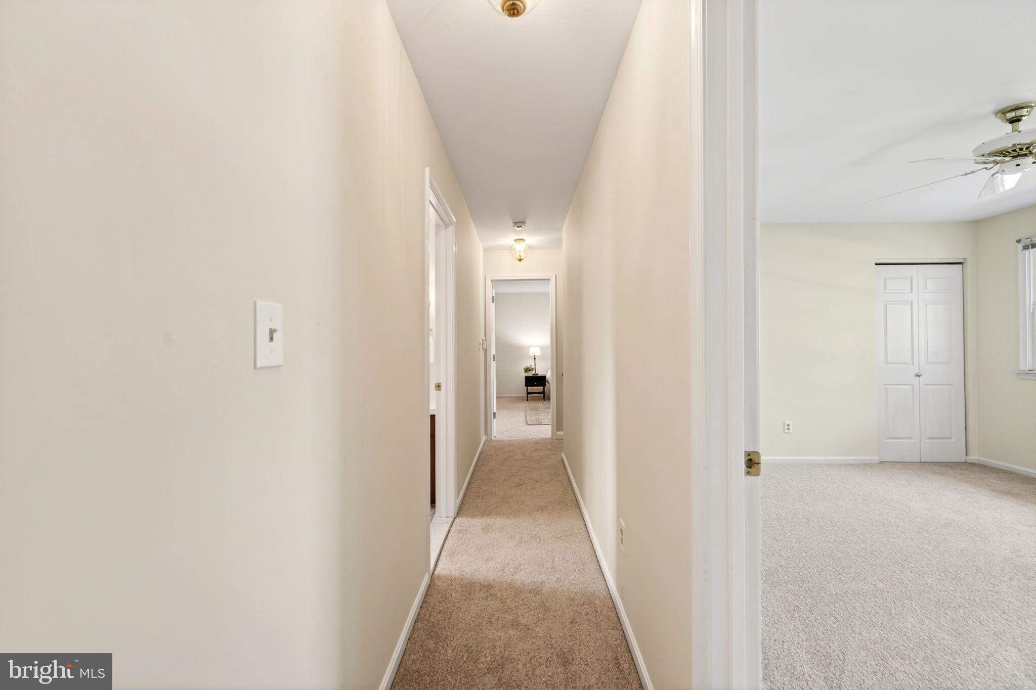 3805 Duddington Way Phoenix, MD 21131 - Photo 35 of 69 a view of a hallway with wooden floor and a bathroom