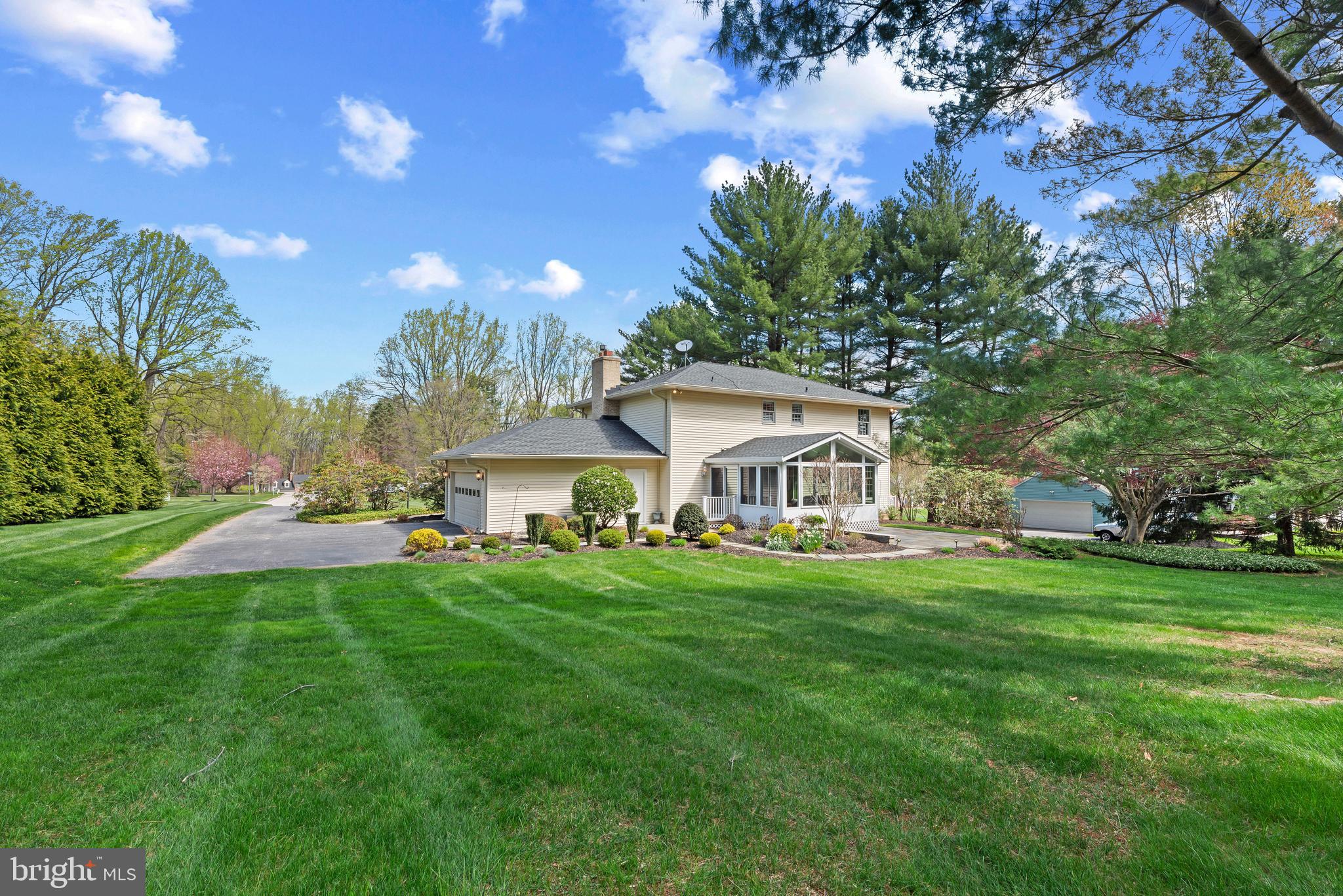 3805 Duddington Way Phoenix, MD 21131 - Photo 61 of 69 a front view of a house with a garden and trees