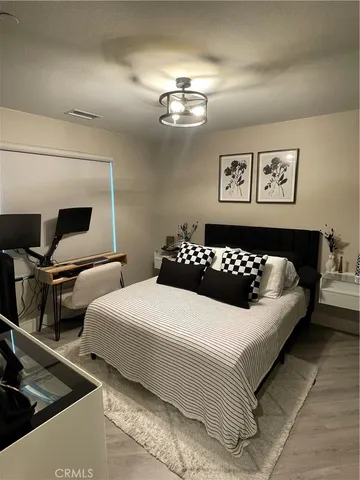 a bedroom with bed and window