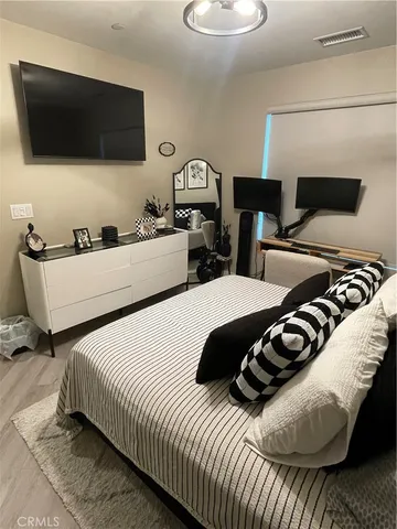 a bedroom with two beds and a television