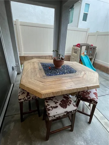 a outdoor dining space with furniture and window