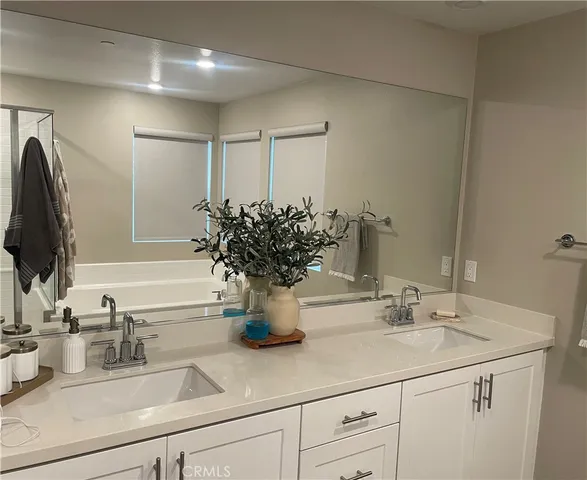 a bathroom with a sink a vanity and a mirror