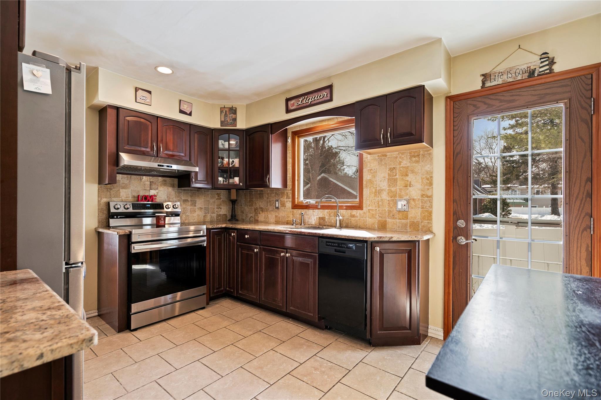 25 State Place Huntington, NY 11743 - Photo 14 of 33 a kitchen with stainless steel appliances granite countertop a stove a sink and a refrigerator