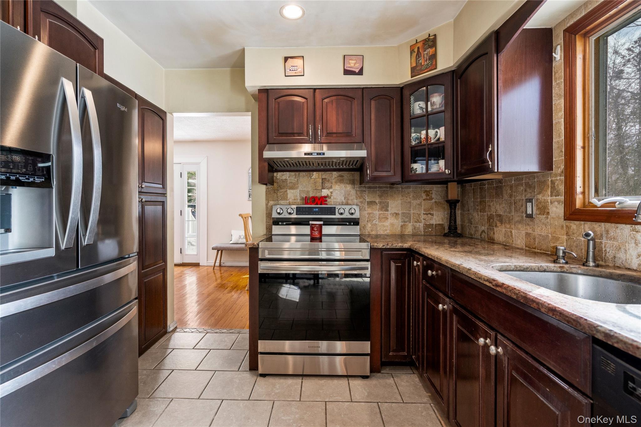 25 State Place Huntington, NY 11743 - Photo 16 of 33 a kitchen with stainless steel appliances granite countertop a refrigerator and a sink
