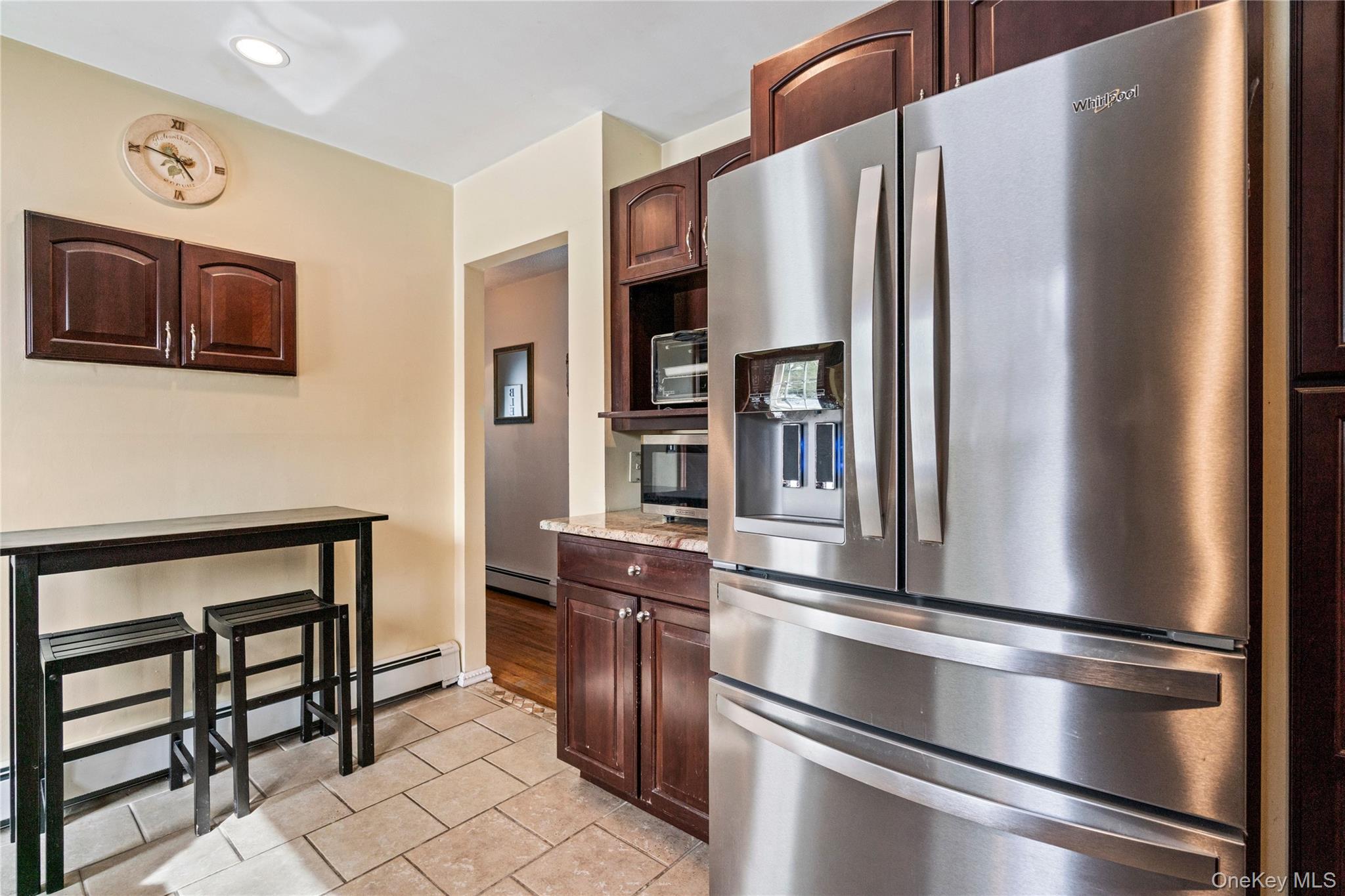 25 State Place Huntington, NY 11743 - Photo 18 of 33 a metallic refrigerator freezer sitting in a kitchen