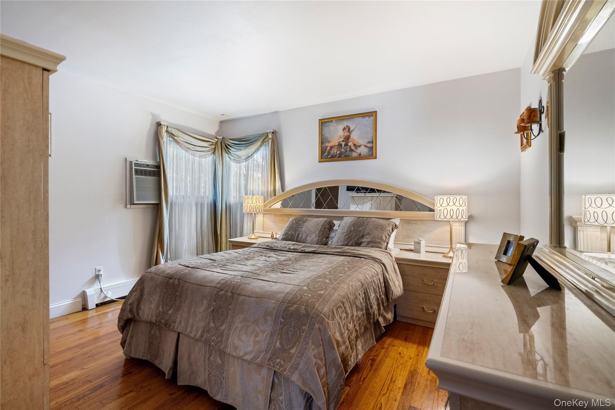 25 State Place Huntington, NY 11743 - Photo 20 of 33 a bedroom with a bed and a large mirror next to a window