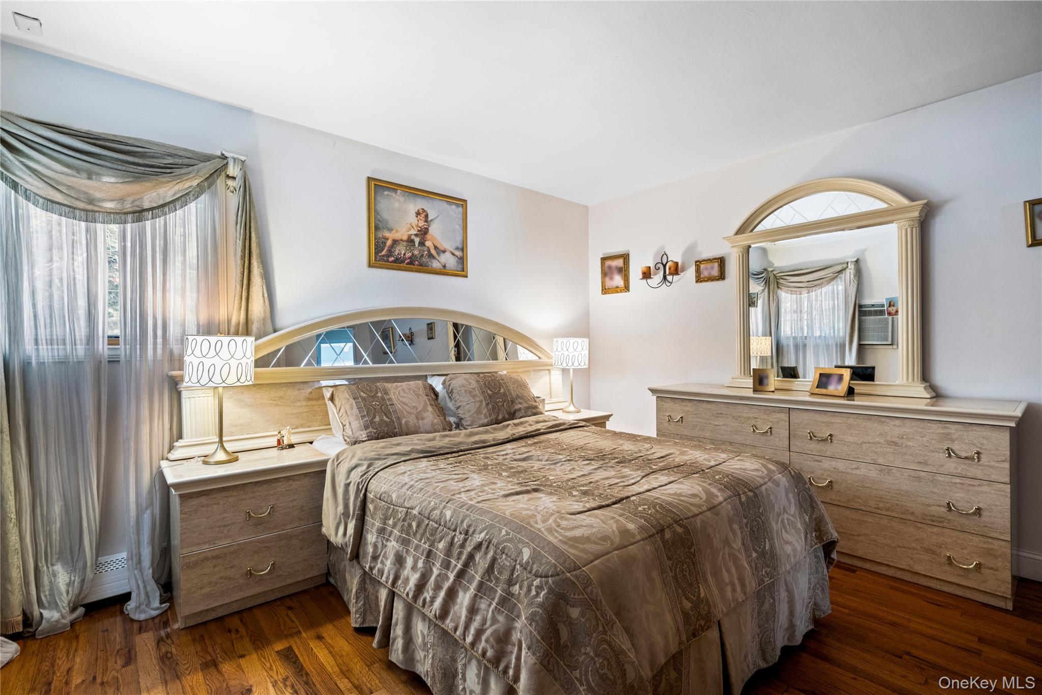 25 State Place Huntington, NY 11743 - Photo 21 of 33 a bedroom with a bed and a mirror on dresser