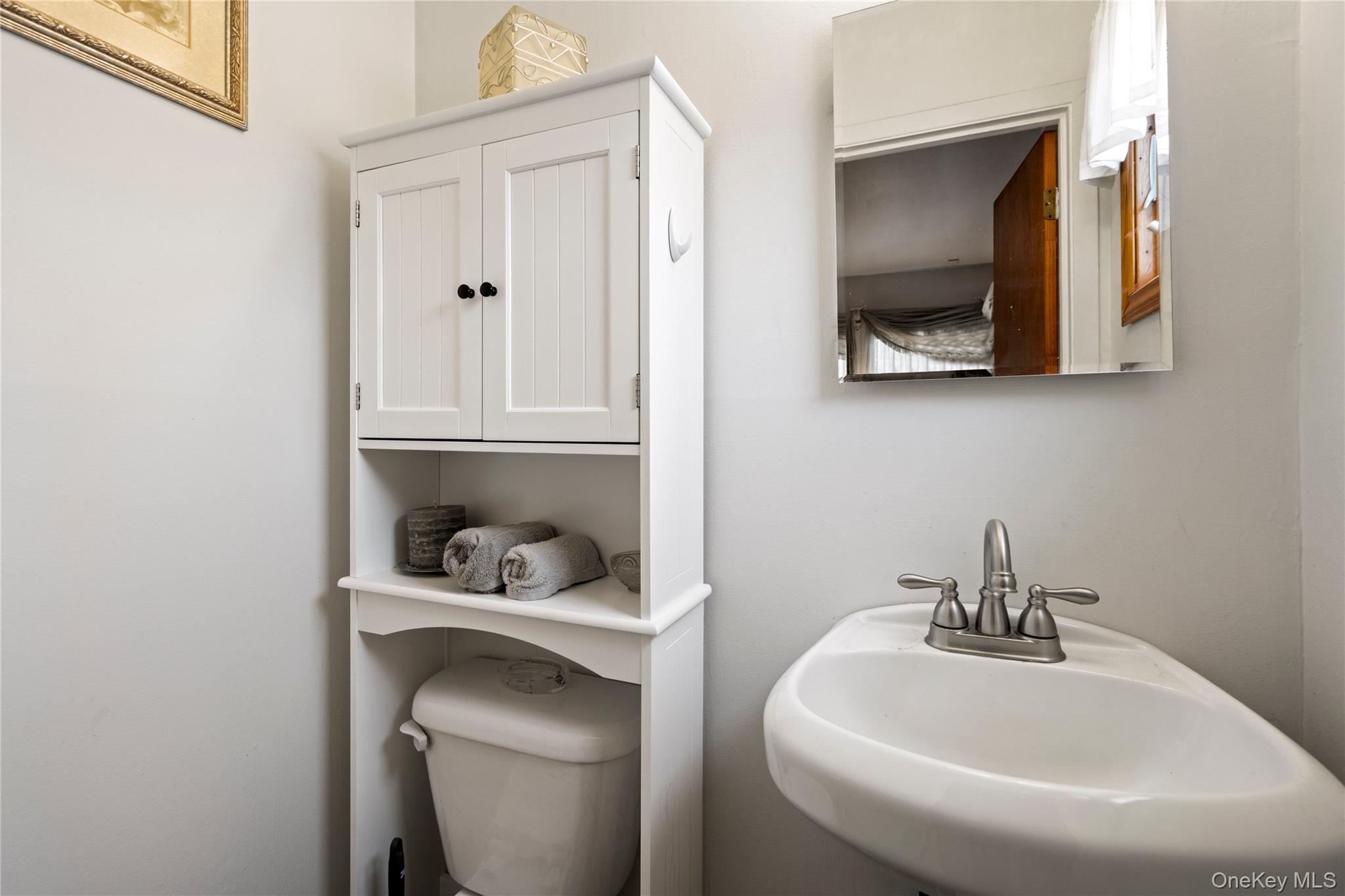 25 State Place Huntington, NY 11743 - Photo 22 of 33 a bathroom with a sink and a toilet