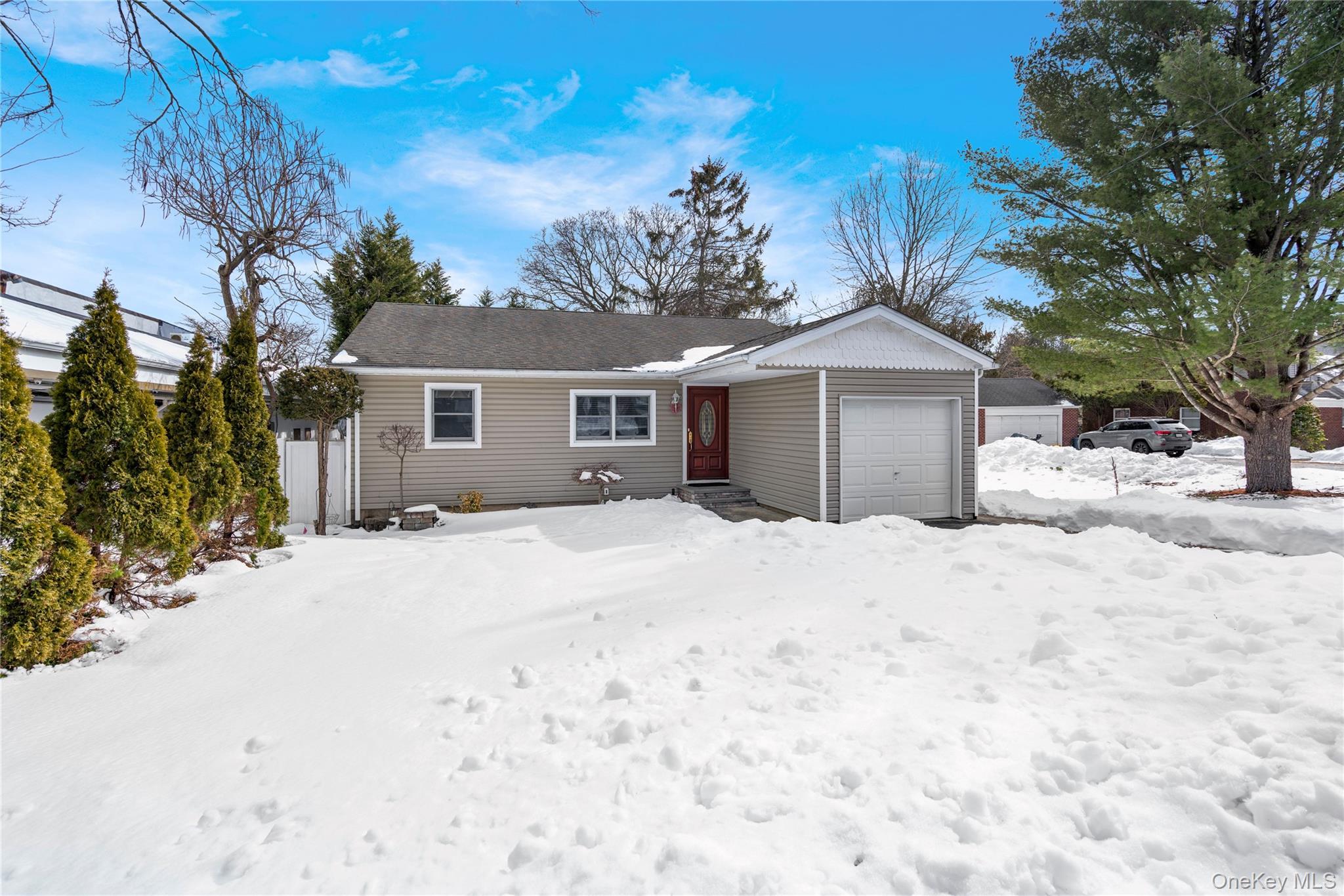 25 State Place Huntington, NY 11743 - Photo 3 of 33 a front view of a house with a yard covered in snow