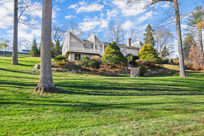 a front view of a house with a garden