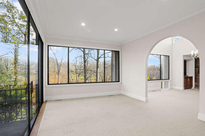 87 Lambert Road New Canaan, CT 06840 - Photo 11 of 39 a view of an empty room with a large window