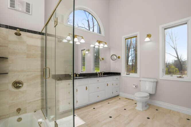 87 Lambert Road New Canaan, CT 06840 - Photo 15 of 39 a bathroom with a granite countertop sink a toilet a mirror and shower