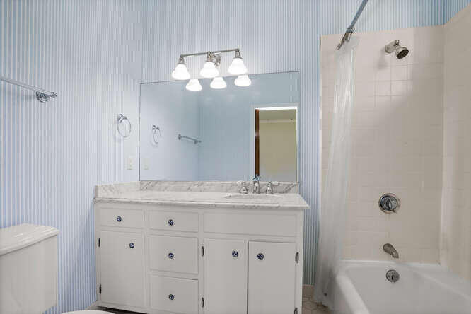 87 Lambert Road New Canaan, CT 06840 - Photo 18 of 39 a bathroom with a sink a large mirror and shower