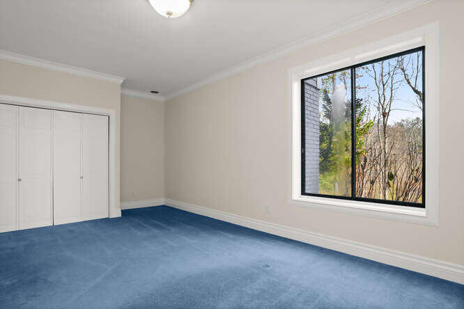 87 Lambert Road New Canaan, CT 06840 - Photo 28 of 39 a view of an empty room with a window