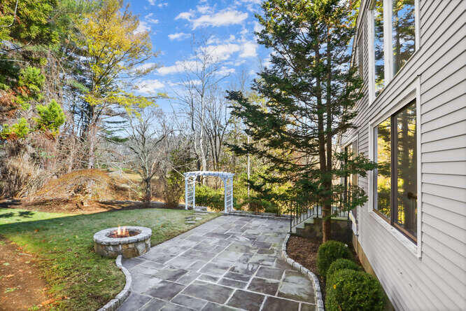 87 Lambert Road New Canaan, CT 06840 - Photo 33 of 39 a backyard of a house with lots of green space
