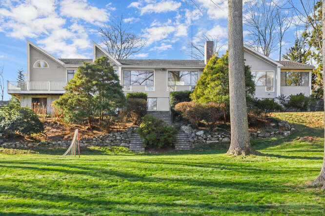 87 Lambert Road New Canaan, CT 06840 - Photo 35 of 39 a front view of a house with garden
