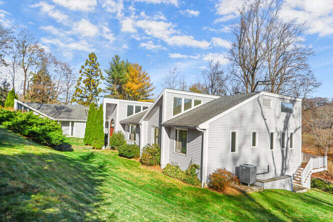 87 Lambert Road New Canaan, CT 06840 - Photo 39 of 39 a view of a white house with a big yard and large tree
