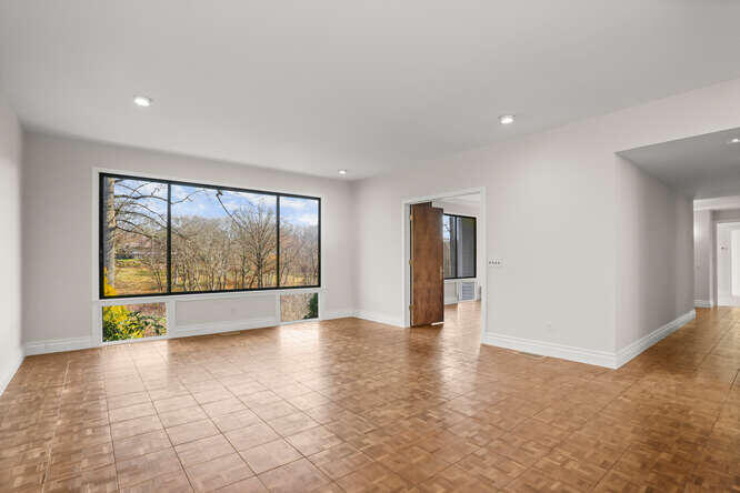 87 Lambert Road New Canaan, CT 06840 - Photo 4 of 39 a view of an empty room with a window
