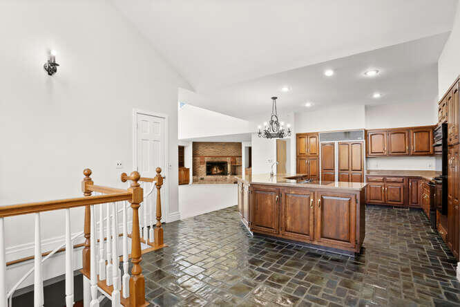 87 Lambert Road New Canaan, CT 06840 - Photo 6 of 39 a living room with lots of wooden furniture and a fireplace