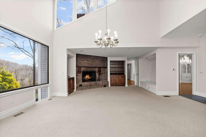 87 Lambert Road New Canaan, CT 06840 - Photo 8 of 39 wooden floor fireplace and windows in an empty room