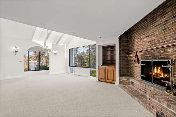 87 Lambert Road New Canaan, CT 06840 - Photo 10 of 39 a view of a livingroom with furniture and a fireplace