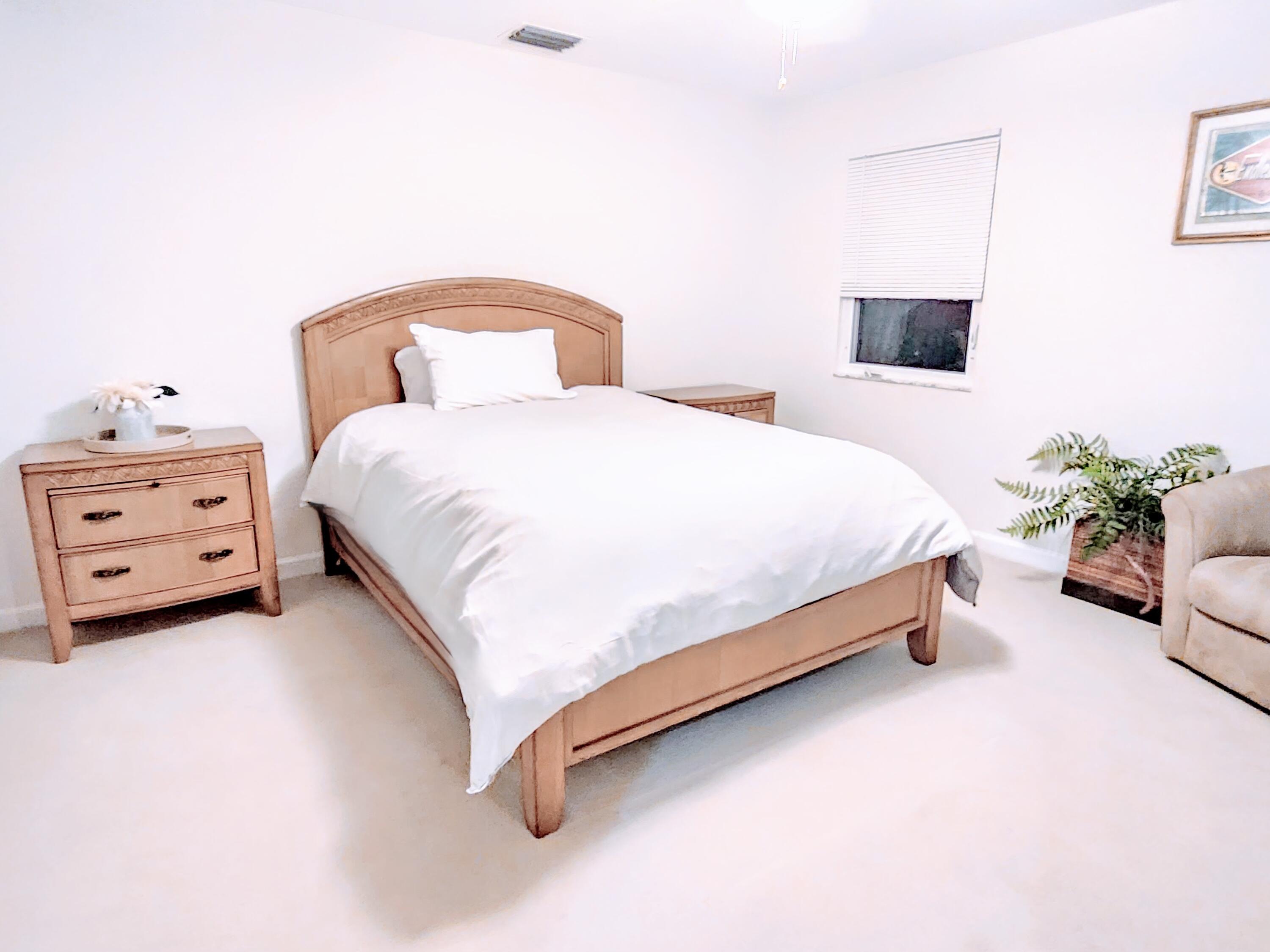 3567 Commodore Circle Delray Beach, FL 33483 - Photo 44 of 76 a bedroom with a bed and a couch