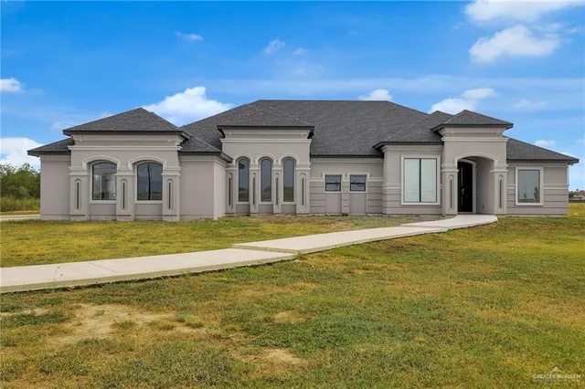 a front view of a house with a yard