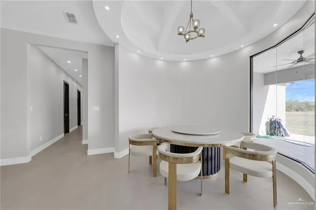 a dining room with a table and chairs