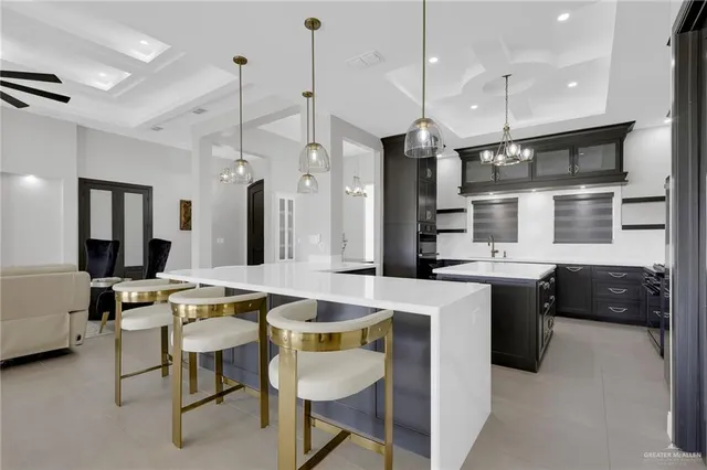 a kitchen with a refrigerator a sink and chairs