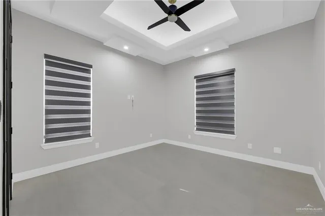 a view of a livingroom with a ceiling fan and window