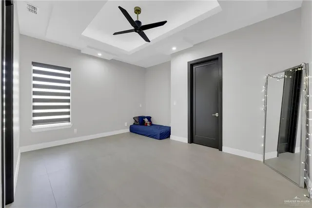 a view of a livingroom with a ceiling fan and window
