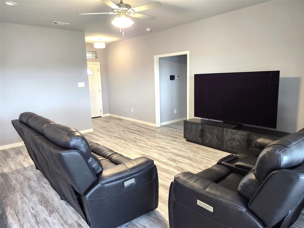 110 Joyce Street Whitney, TX 76692 - Photo 2 of 13 a living room with furniture and a flat screen tv