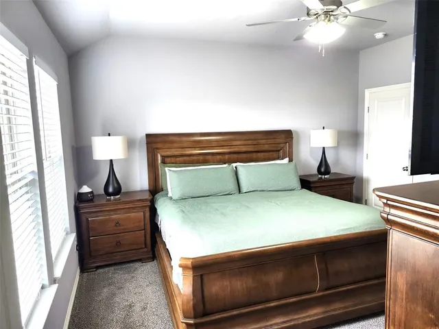 a bedroom with a bed and a lamp