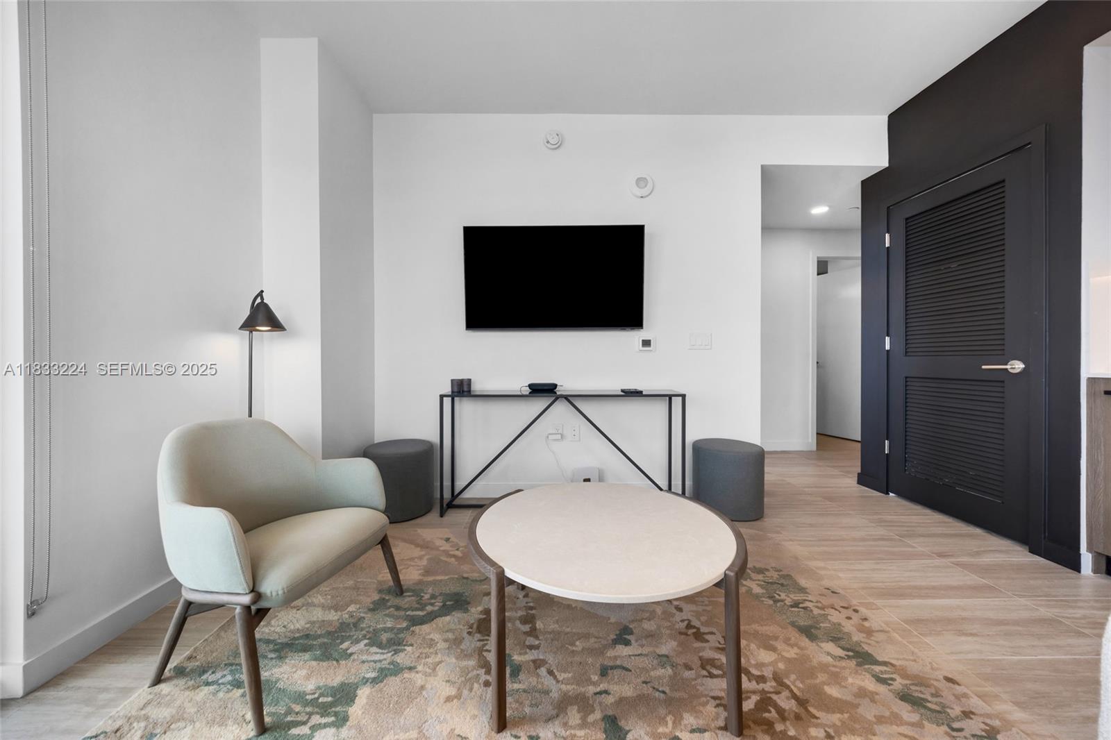 580 72nd Street, Unit 910 Miami Beach, FL 33141 - Photo 31 of 60 a living room with furniture and a flat screen tv