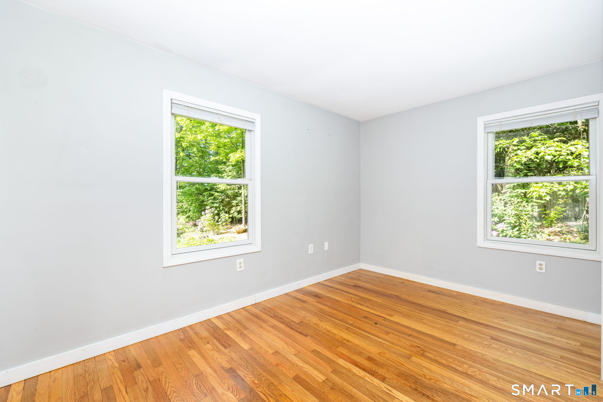347 Griffin Road Suffield, CT 06093 - Photo 19 of 35 a view of an empty room with wooden floor and a window