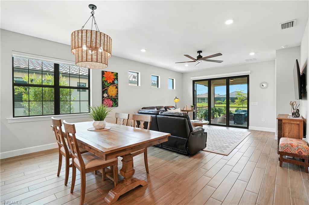 11945 Sacra Place Fort Myers, FL 33913 - Photo 11 of 50 Dining area featuring light wood-type flooring, ceiling fan, a chandelier, and recessed lighting
