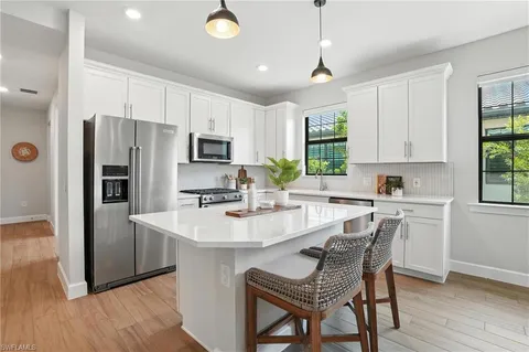 a kitchen with a stove a sink and a refrigerator