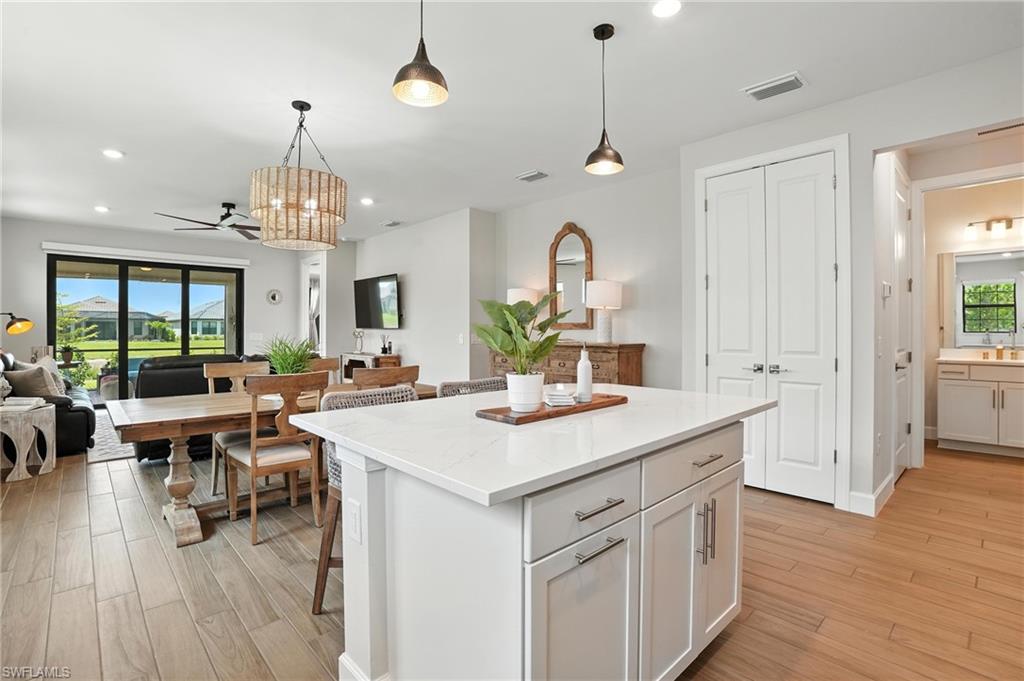 11945 Sacra Place Fort Myers, FL 33913 - Photo 14 of 50 Kitchen featuring open floor plan, a center island, light wood finished floors, decorative light fixtures, and recessed lighting