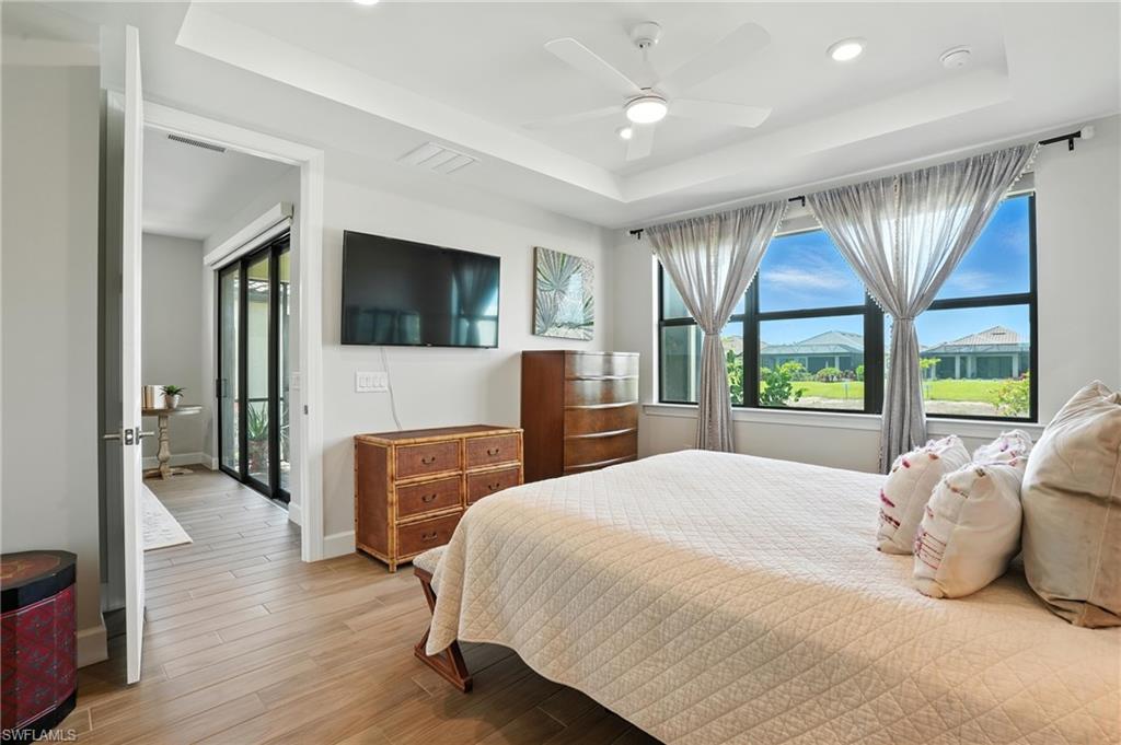 11945 Sacra Place Fort Myers, FL 33913 - Photo 20 of 50 Bedroom featuring a raised ceiling, light wood-type flooring, recessed lighting, and a ceiling fan