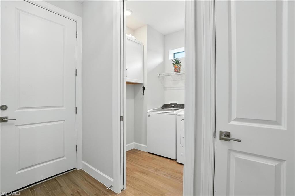 11945 Sacra Place Fort Myers, FL 33913 - Photo 28 of 50 Laundry room featuring light wood-style floors and washer and clothes dryer
