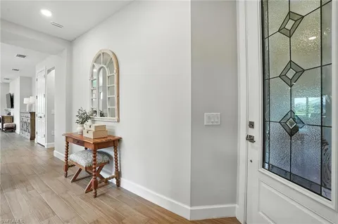 a view of a room with wooden floor table and chairs